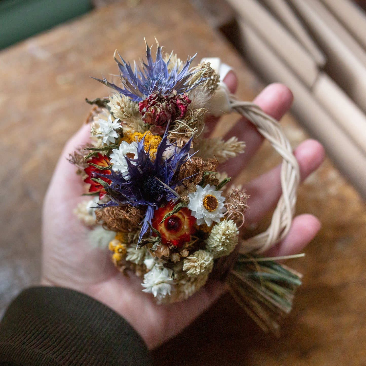 hand holding a mini gift wreath