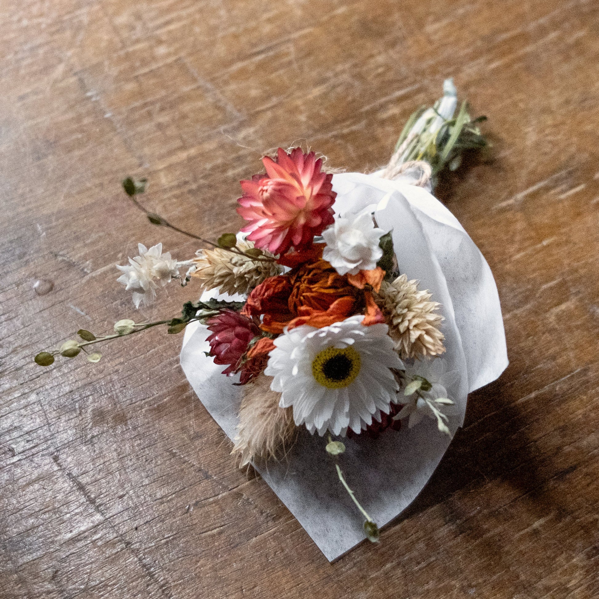 dried flower orange and white tried flowers wrapped in white tissue paper 