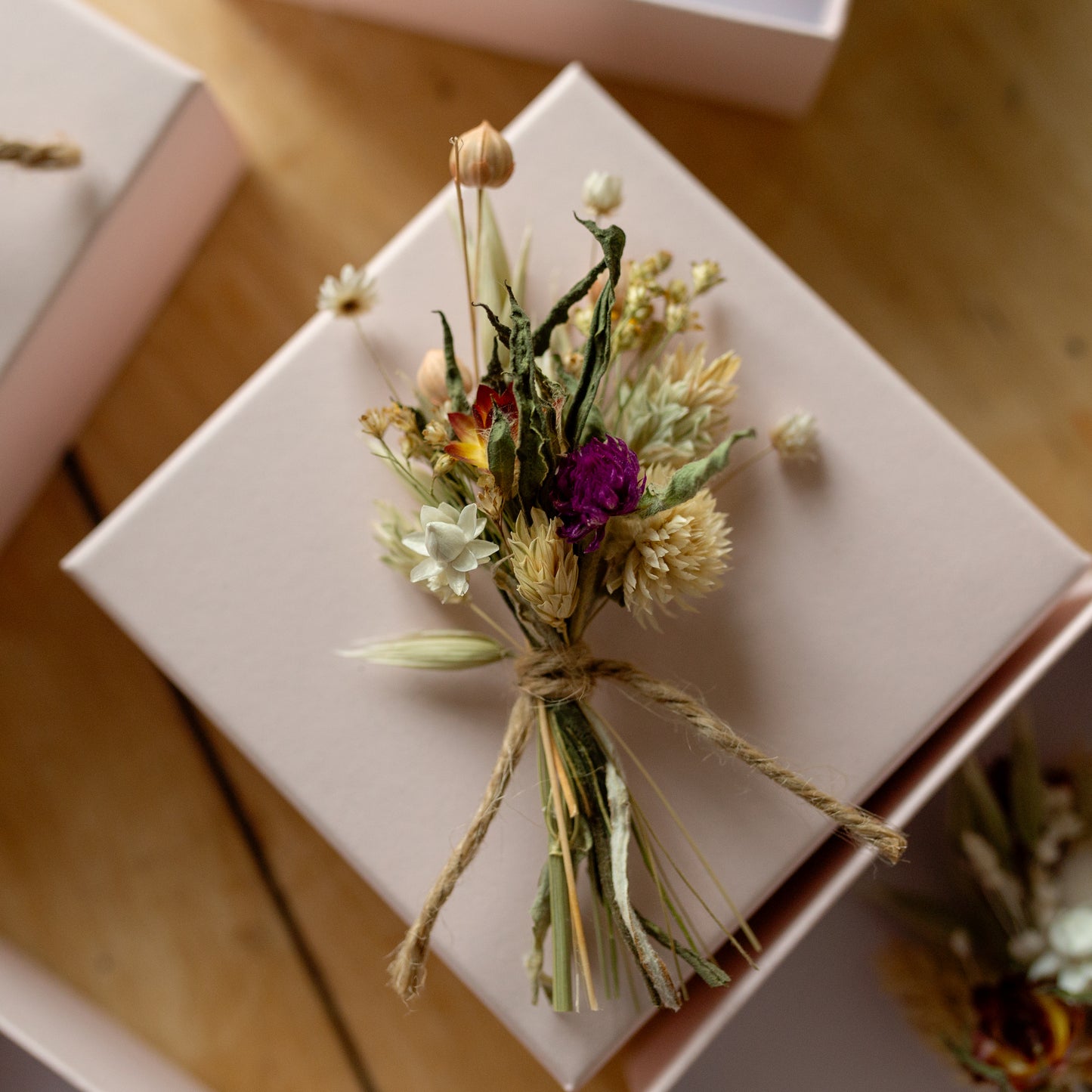 dried flower pink and cream gift size posy tied together with twine in a pale pink gift box