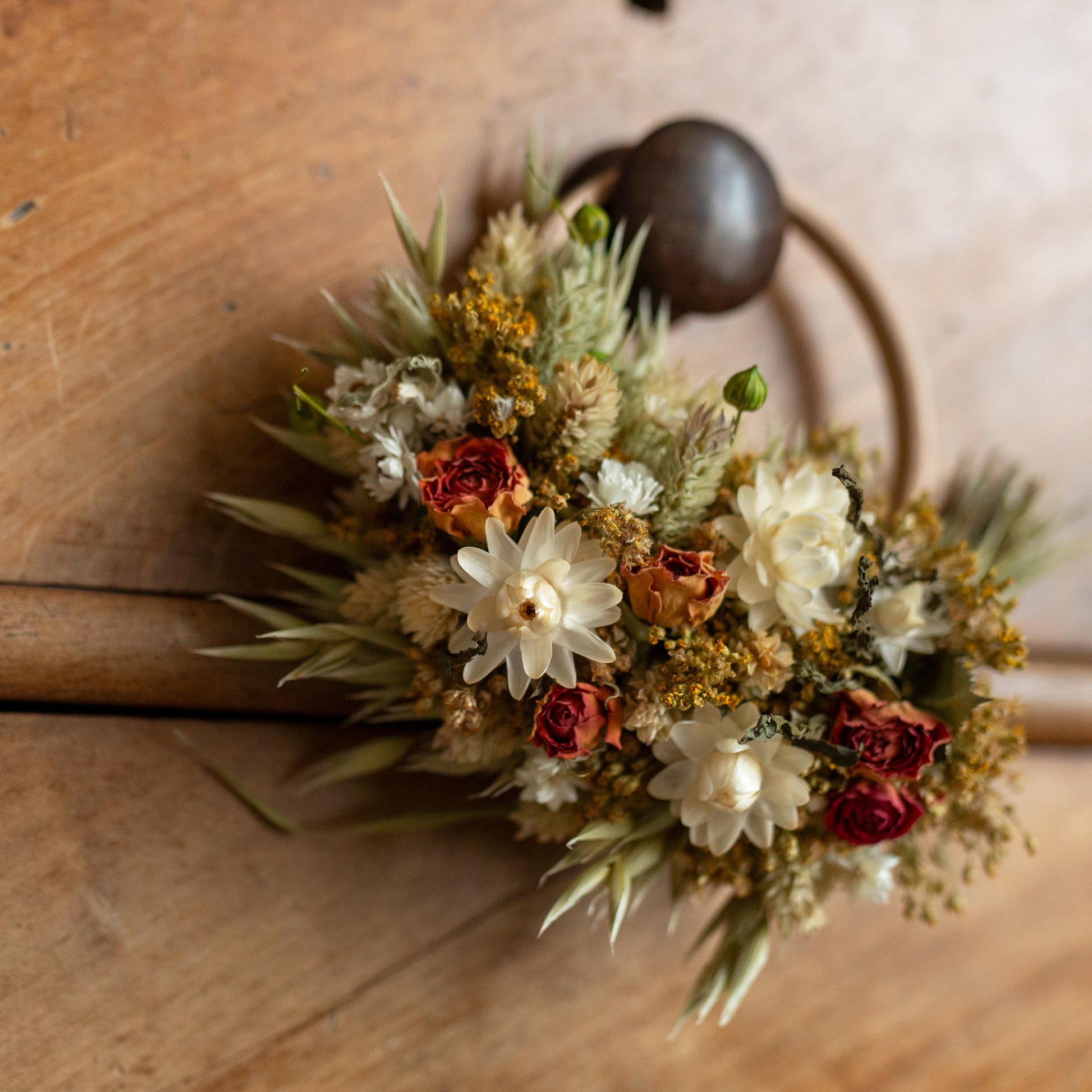 close up of the flower on mini hoop circle wreath made of dried flowers hung on a drawer knob