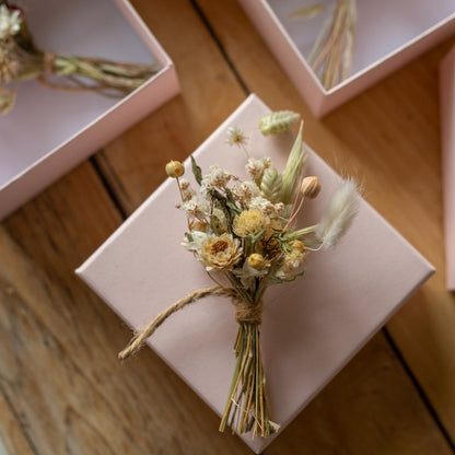 neutral coloured mini posy on top of a pale pink gift box