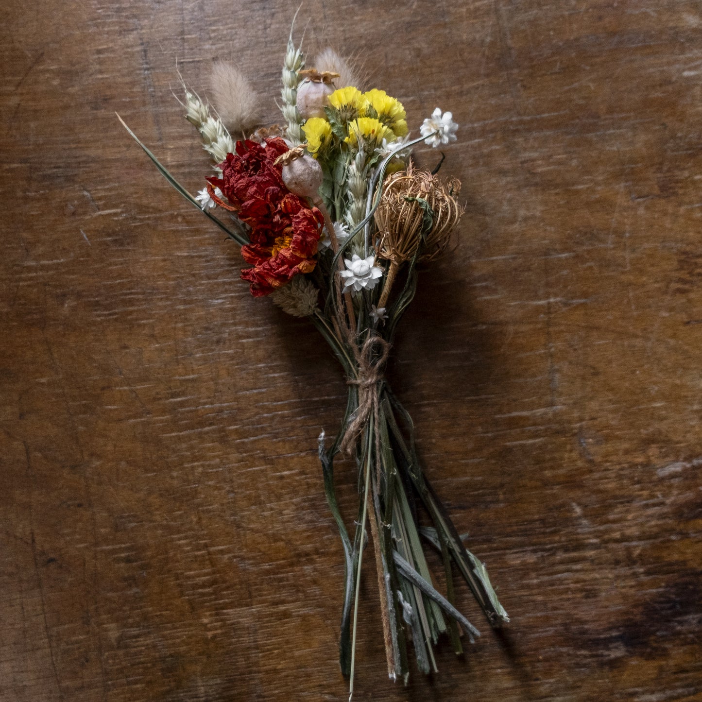 Bouquet posy of dried flowers on a wooden surface