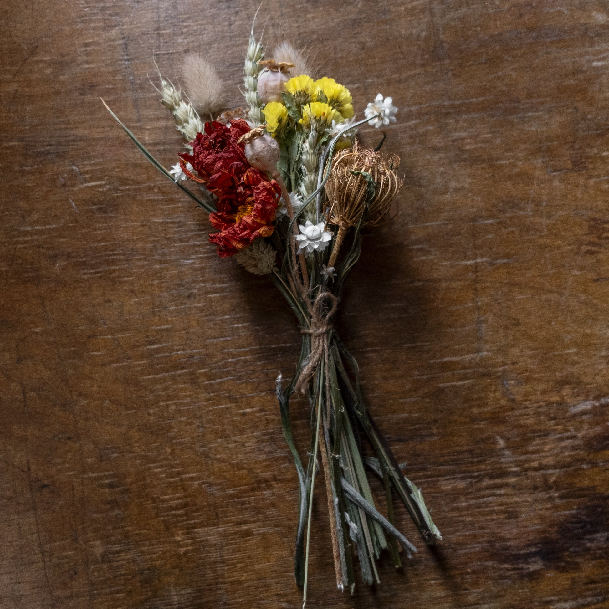 Bouquet posy of dried flowers on a wooden surface