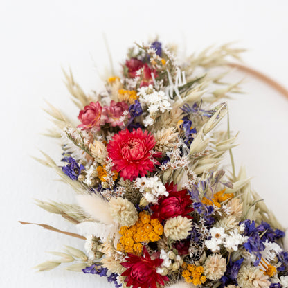 red, white blue and yellow dried flower wreath close up on strawflower 